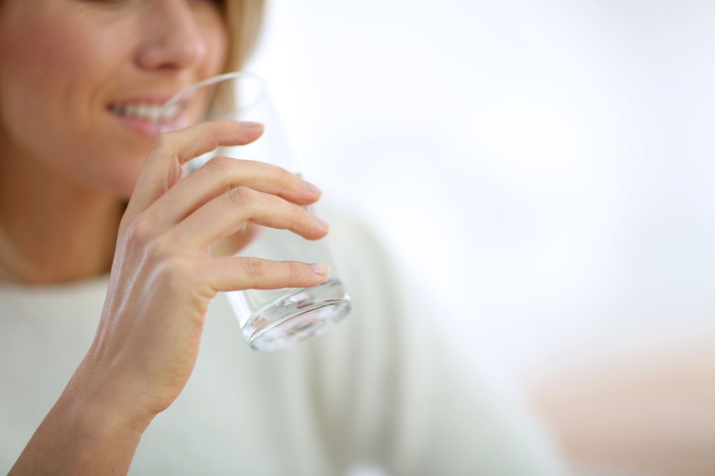 Woman drinks glass of water